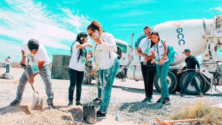 people planting trees in front of a GCC ready mix truck